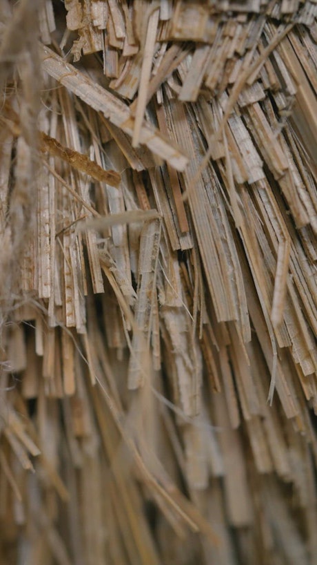 Stacked thin strips of old weathered wood.