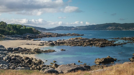 View of a beautiful beach full of rocks.