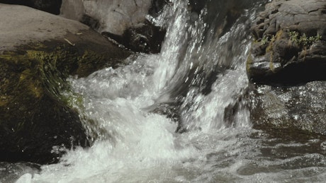 Water crashes among rocks.