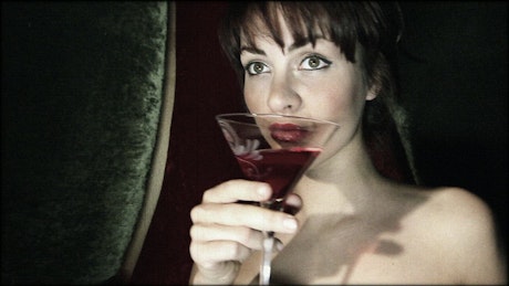 Woman drinking a cocktail.