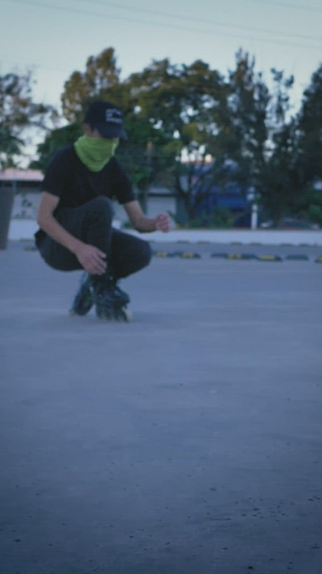 Young man skating in a parking lot.