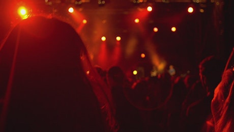 Young women jumping at the concert.