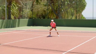 Attractive Young Woman Enjoying a Game Of Tennis.