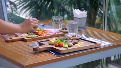 A Waitress Sets the Table in a Restaurant.