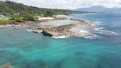 Aerial footage off the coast of the tropical Island of Hawaii featuring Shark's Cove with lots of ro.