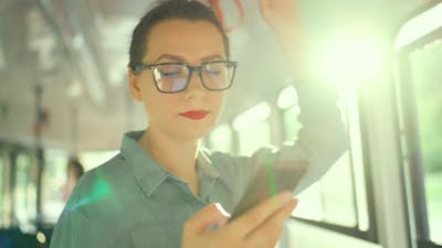 Public Transport Woman in Glasses in Tram Using Smartphone Slow Motion.