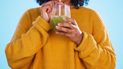 Health juice, black woman hands and healthy green smoothie of a person drinking weight loss drink.
