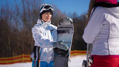 Portrait of Confident Fit Caucasian Sportswoman Arguing with Friend About Better Winter Sport.