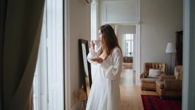 Calm Woman Drinking Tea at Morning Home Interior.