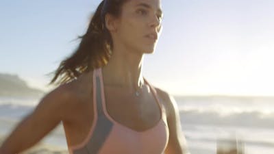 Fitness, beach and woman running for cardio exercise, healthy lifestyle.