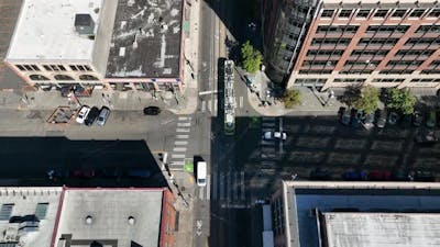 Top down aerial shot of an electric street car traveling through Seattle's industrial streets..