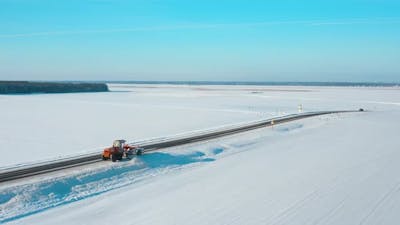 Aerial View Snow Removal Tractor Clears Road From Snow.